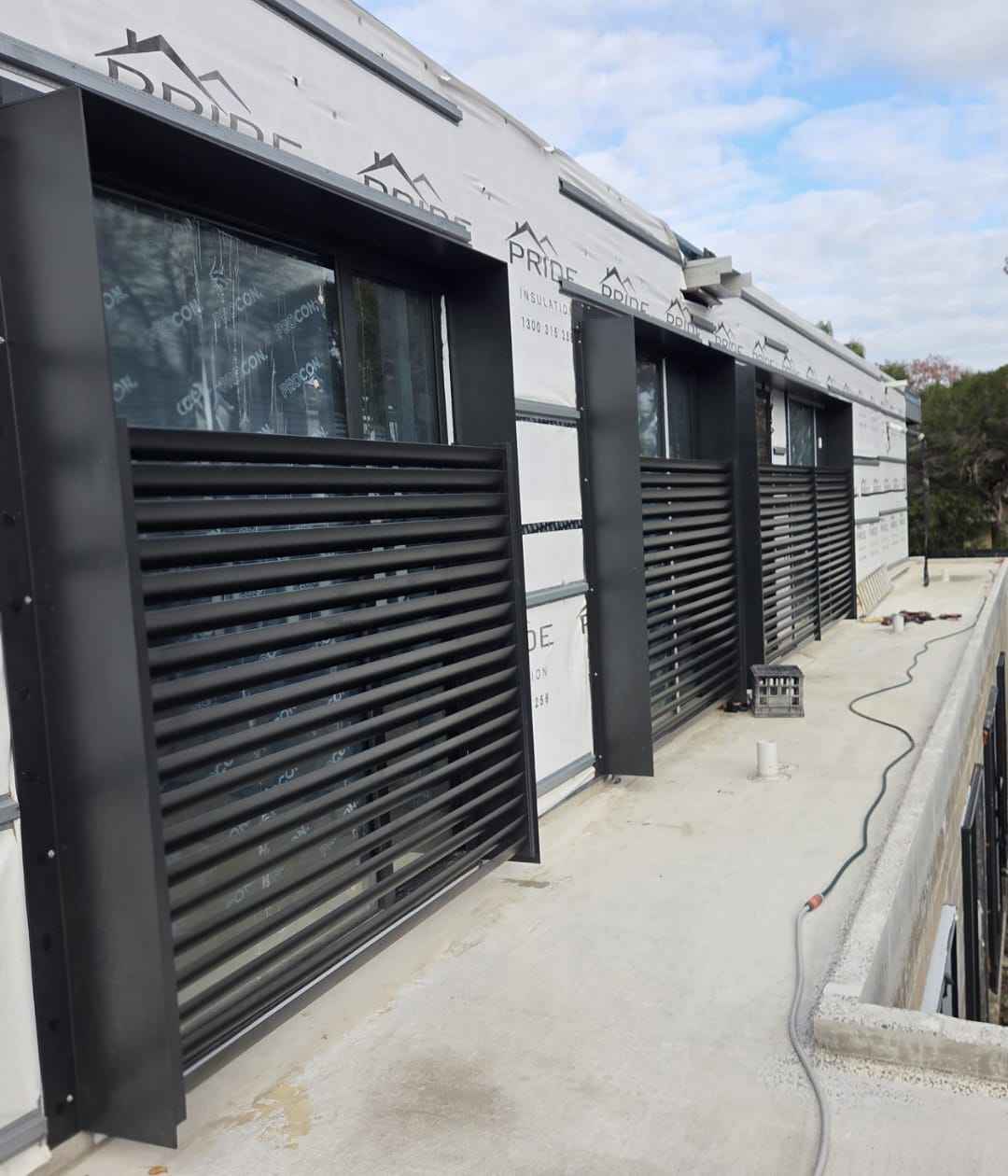 Black horizontal slat privacy screen on a townhouse