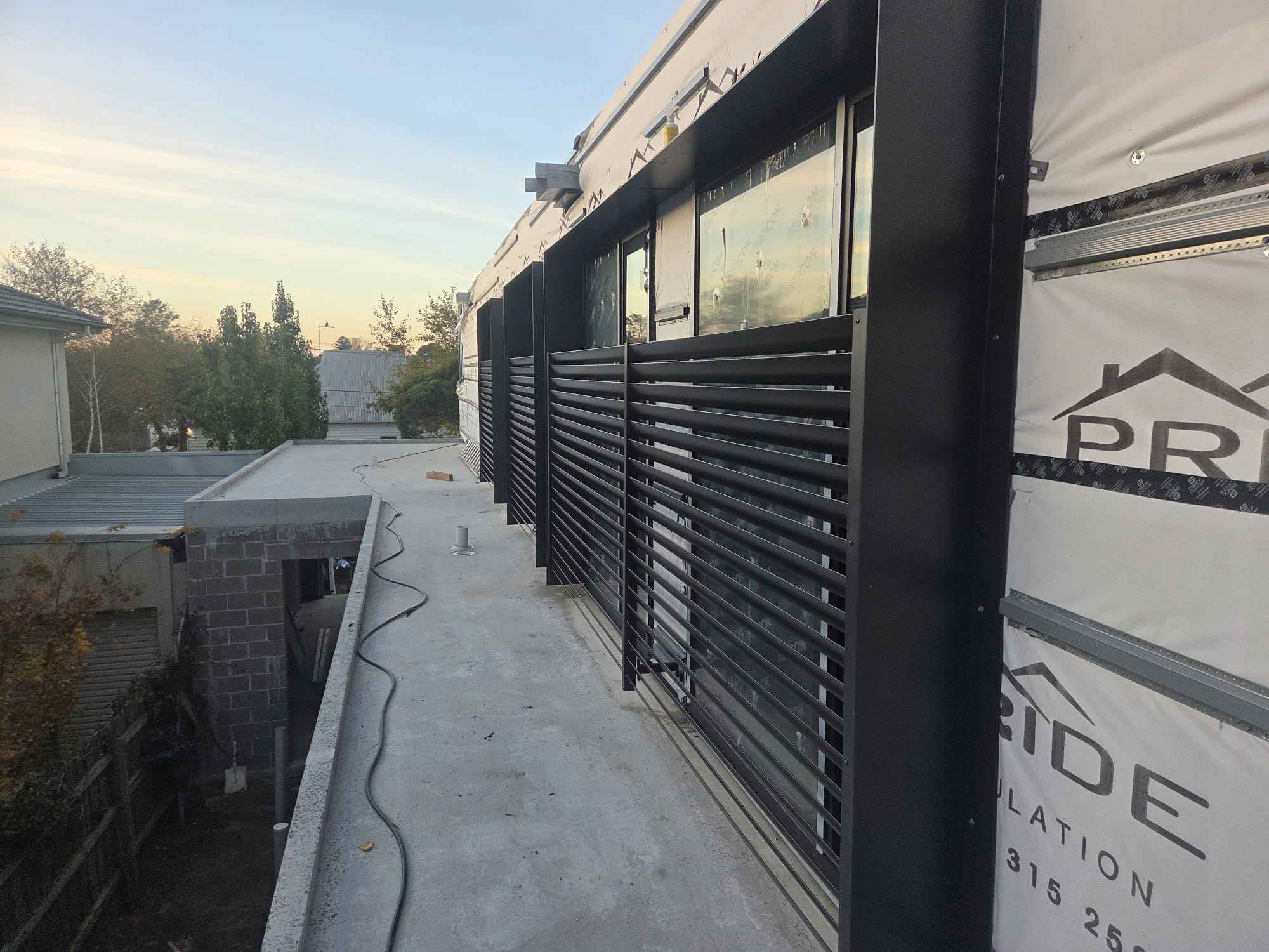 Aluminium slat screens running the length of a townhouse