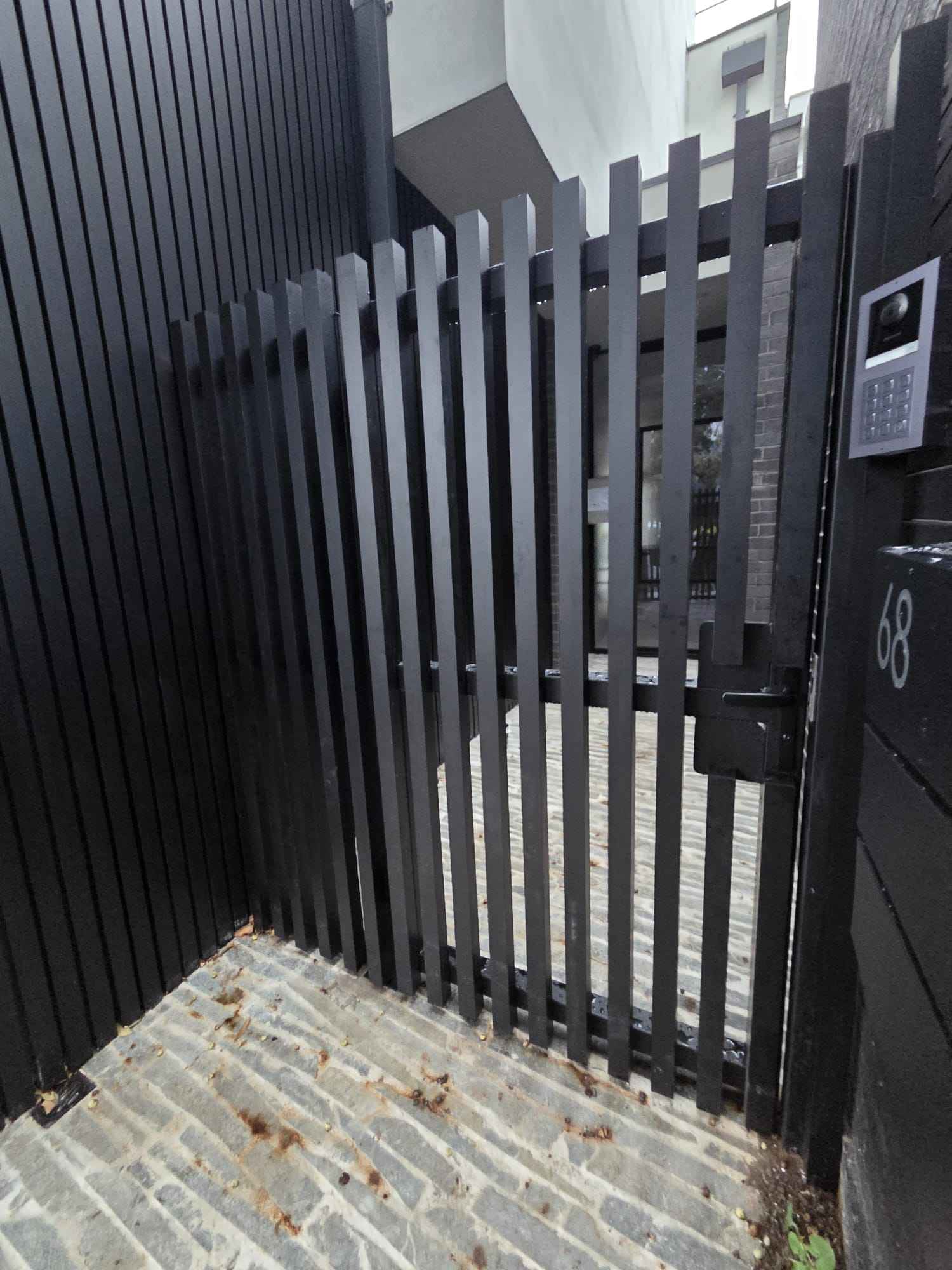 Black slat pedestrian gate by True-Line Installs